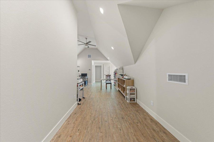 Bonus room featuring wood finished floors, lofted ceiling, recessed lighting, and a ceiling fan Bonus room featuring wood finished floors, lofted ceiling, recessed lighting, and a ceiling fan