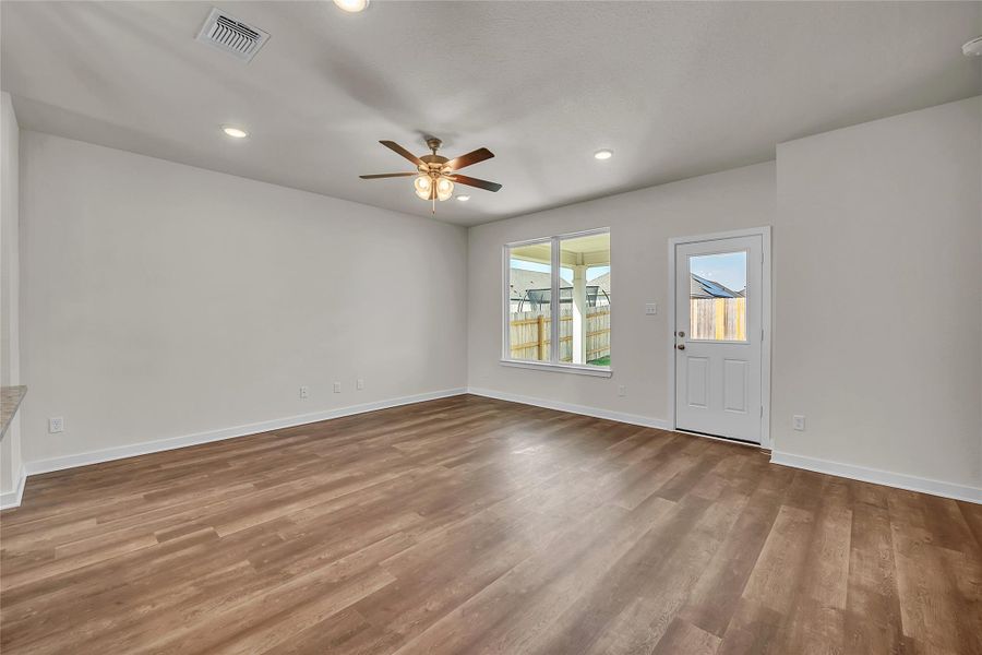 Unfurnished room with recessed lighting, light wood finished floors, and a ceiling fan Unfurnished room with recessed lighting, light wood finished floors, and a ceiling fan