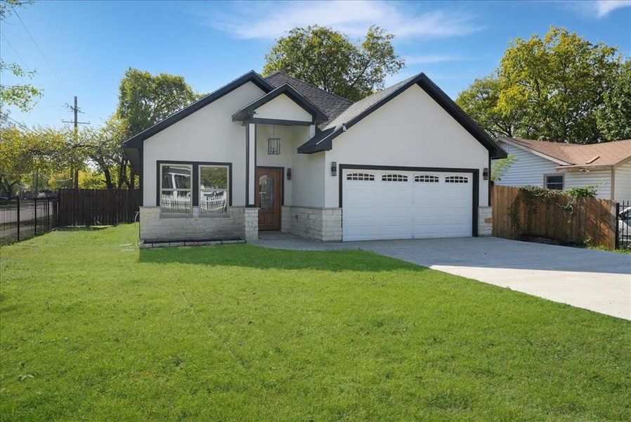 View of front of home featuring stone siding, stucco siding, concrete driveway, and an attached garage