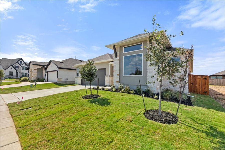 Prairie-style home with stucco siding, driveway, and a garage