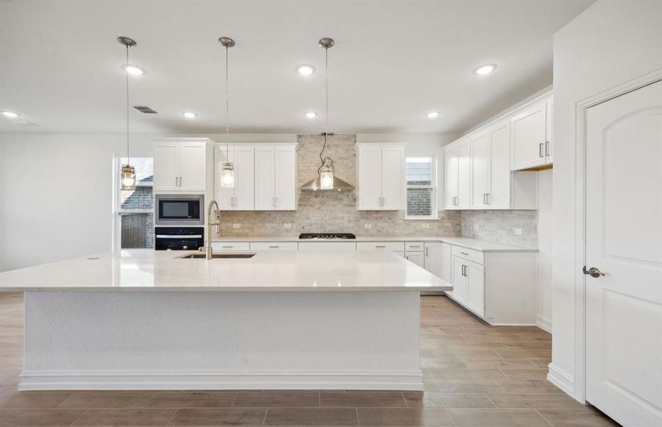 Bright kitchen with oversized island *real home pictured