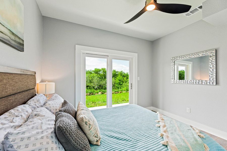 Sliding glass door opening to a green landscape