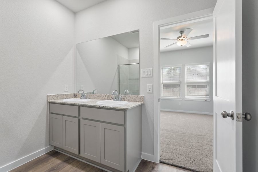 A bathroom with a sink and a mirror. A bathroom with a sink and a mirror.
