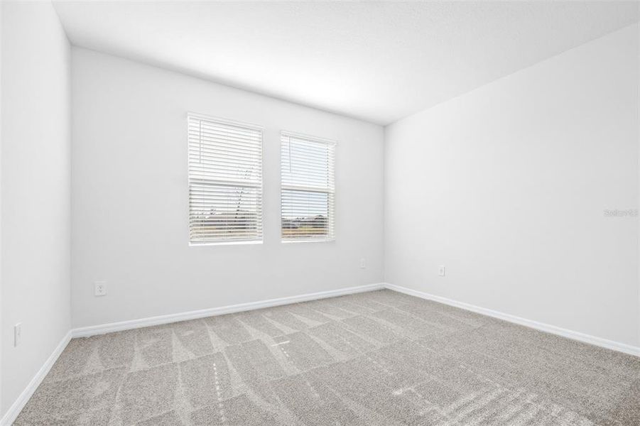 Spacious, unfurnished interior of a new home in The Grove at Stuart Crossing - Premier Series, Bartow (Image 32).