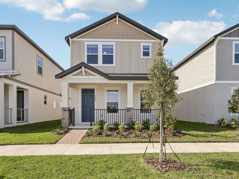 Front exterior of a new home in The Meadow at Crossprairie Bungalows, St. Cloud, FL, highlighting curb appeal (Image 1). Front exterior of a new home in The Meadow at Crossprairie Bungalows, St. Cloud, FL, highlighting curb appeal (Image 1).