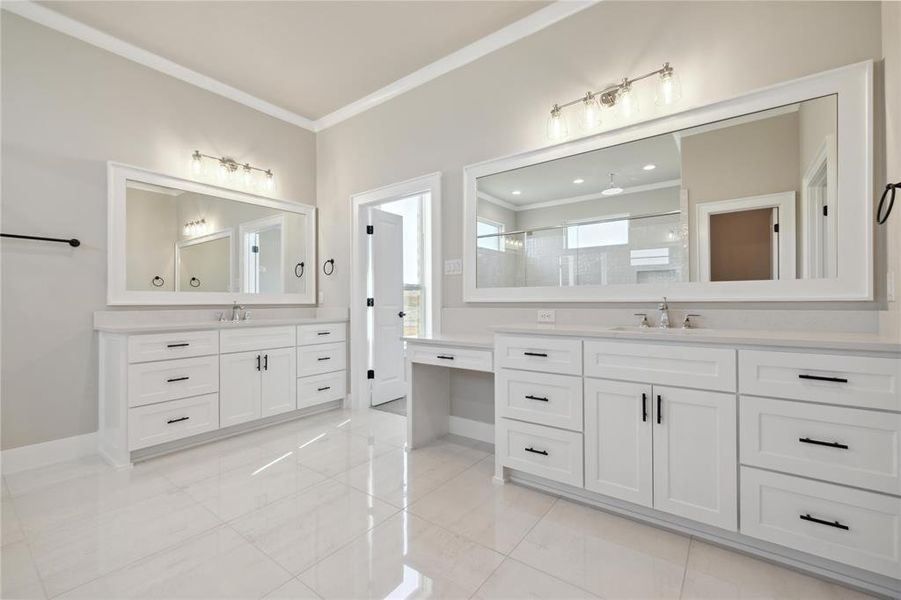 Bathroom featuring walk in shower, vanity, and ornamental molding