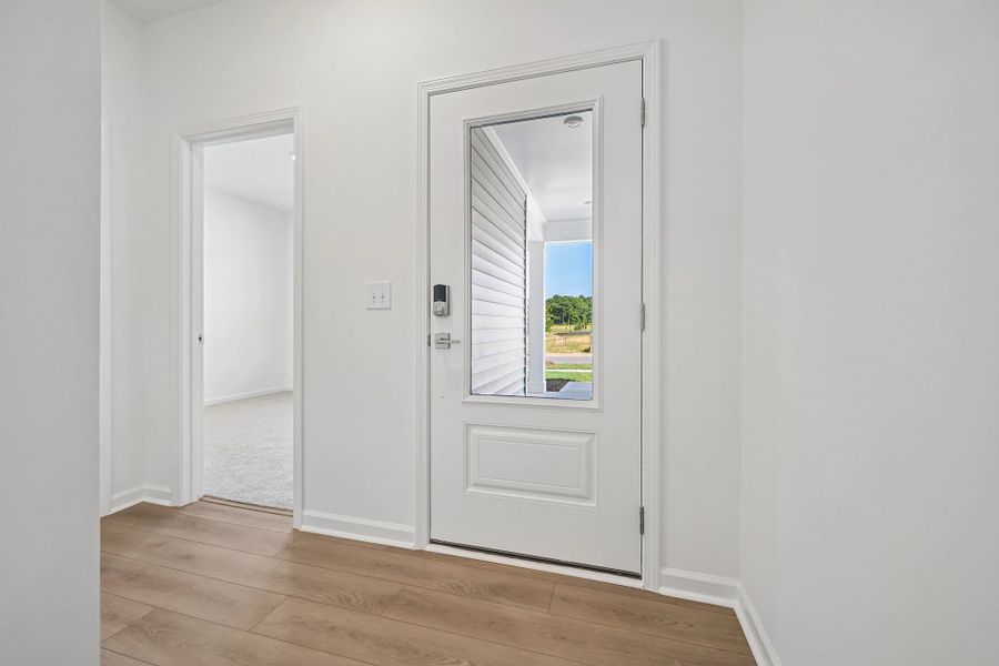 Foyer featuring the AW Collection® Milan - An entry with sleek tones and gallery-style flair.