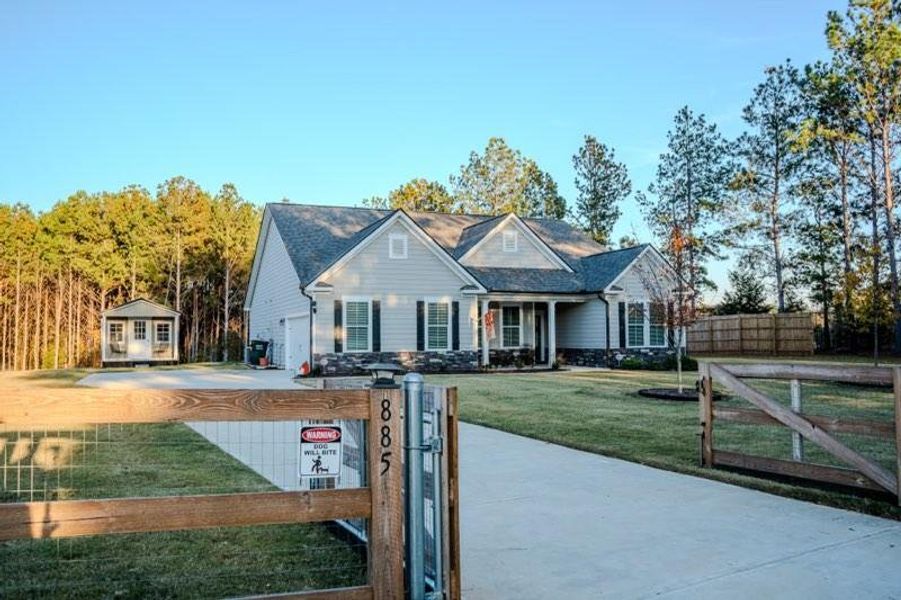 Front exterior of a new home in Crossing Creeks, Monroe, GA, highlighting curb appeal (Image 1).
