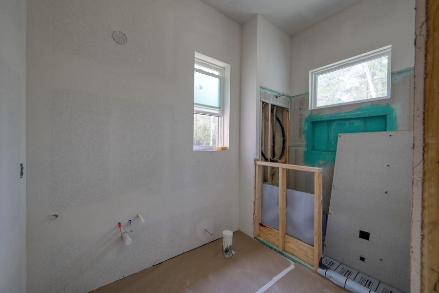 Spacious and private, this secondary en-suite bathroom offers floor to ceiling tile flooring in the shower.