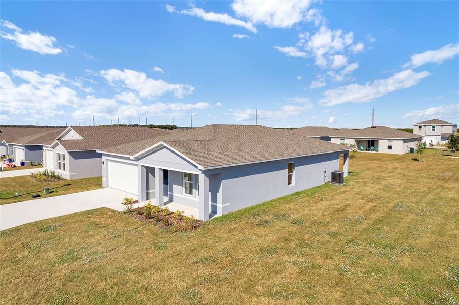 Front exterior of a new home in Stone Ridge, Sebring, FL, highlighting curb appeal (Image 8).
