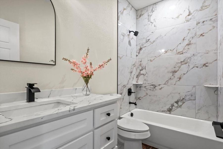 Full bathroom featuring tub / shower combination and vanity Full bathroom featuring tub / shower combination and vanity