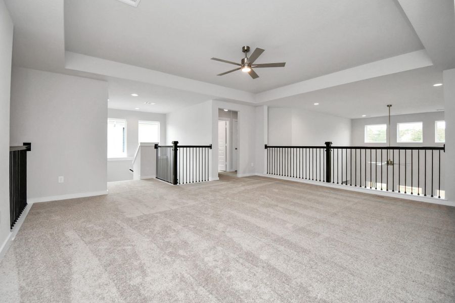 Ascend to relaxation in this fantastic game room! Ideal for both casual gatherings and adult gaming, it boasts plush carpet, lofty ceilings, custom paint, and ample windows for abundant natural light. Sample photo of completed home with similar floor plan. Actual colors and selections may vary. Ascend to relaxation in this fantastic game room! Ideal for both casual gatherings and adult gaming, it boasts plush carpet, lofty ceilings, custom paint, and ample windows for abundant natural light. Sample photo of completed home with similar floor plan. Actual colors and selections may vary.