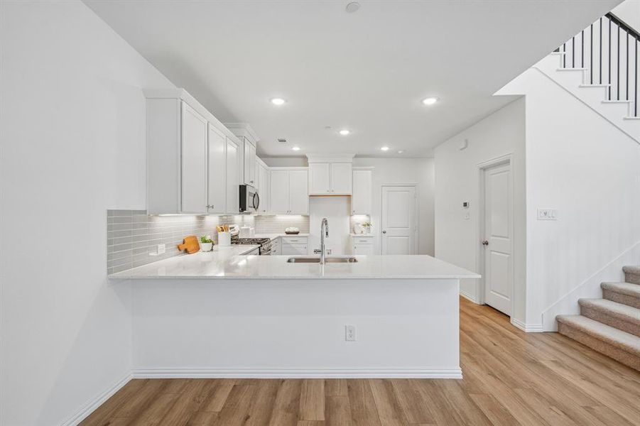 The kitchen peninsula with breakfast bar makes this the perfect place to grab a quick bite. The kitchen peninsula with breakfast bar makes this the perfect place to grab a quick bite.