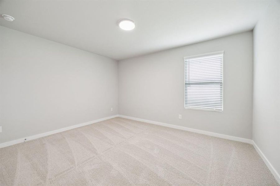 Bedroom in the Hayden home plan by Trophy Signature Homes – REPRESENTATIVE PHOTO