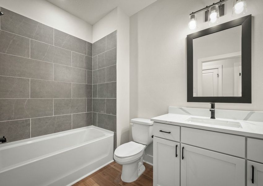 Secondary bathroom with vanity.