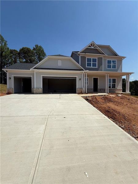 Front exterior of a new home in Traditions of Braselton, Hoschton, GA, highlighting curb appeal (Image 24).