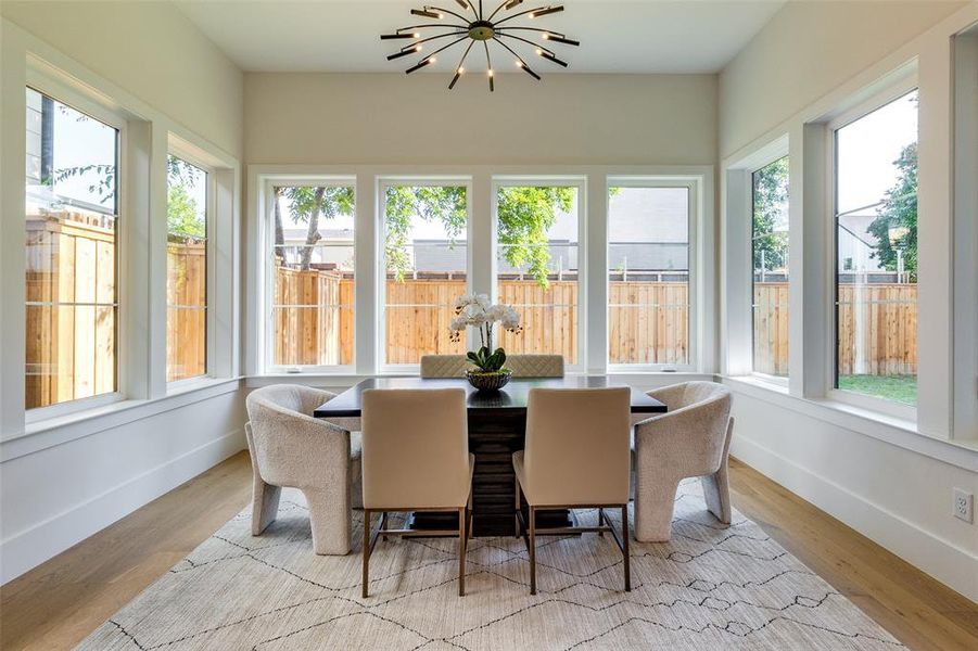 Sunroom featuring a chandelier and a healthy amount of sunlight