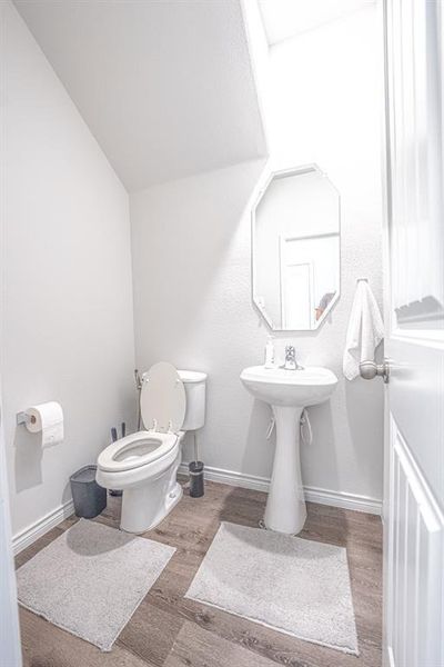 Bathroom featuring toilet and wood finished floors