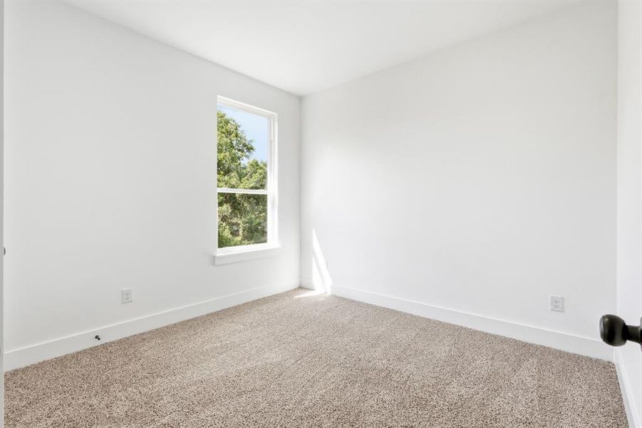 Room featuring a single-pane window, white walls, and light brown carpet flooring Room featuring a single-pane window, white walls, and light brown carpet flooring