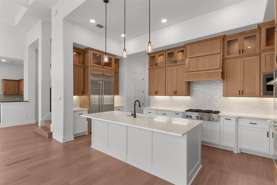 A well-appointed kitchen showcasing a spacious island and gleaming hardwood floors.