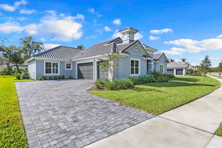 Front exterior of a new home in Toscana, Palm Coast, FL, highlighting curb appeal (Image 15).