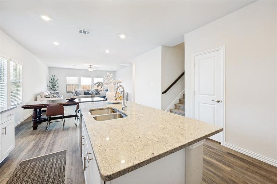 Kitchen island featuring a double basin stainless steel sink and light-toned countertop Kitchen island featuring a double basin stainless steel sink and light-toned countertop