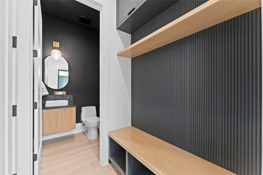 Mud room with tall cabinet with custom profile and white oak shelves.