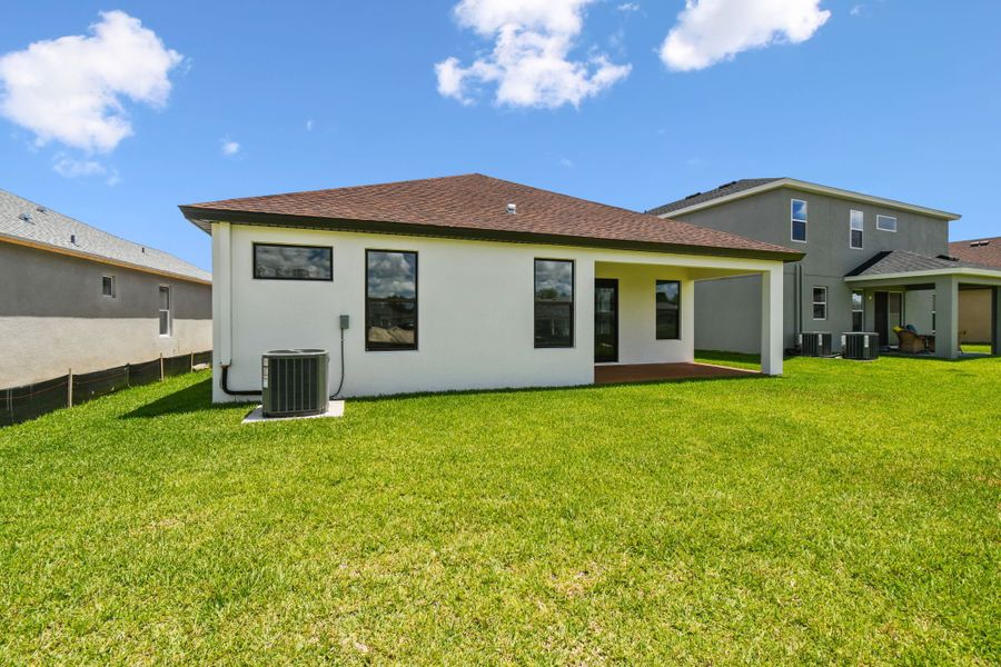 Front exterior of a new home in Avalon West, Spring Hill, FL, highlighting curb appeal (Image 60).