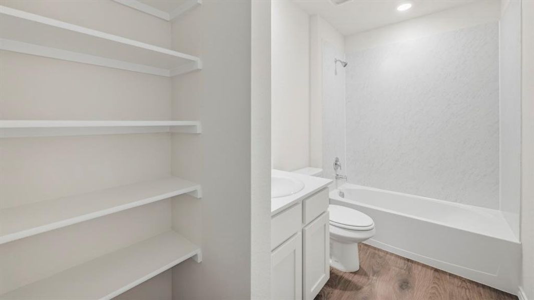 Full bath with vanity, dark wood-style flooring, bathing tub / shower combination, a closet, and recessed lighting
