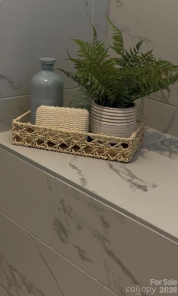 Owners bath tiled shower w bench seat - model home photos