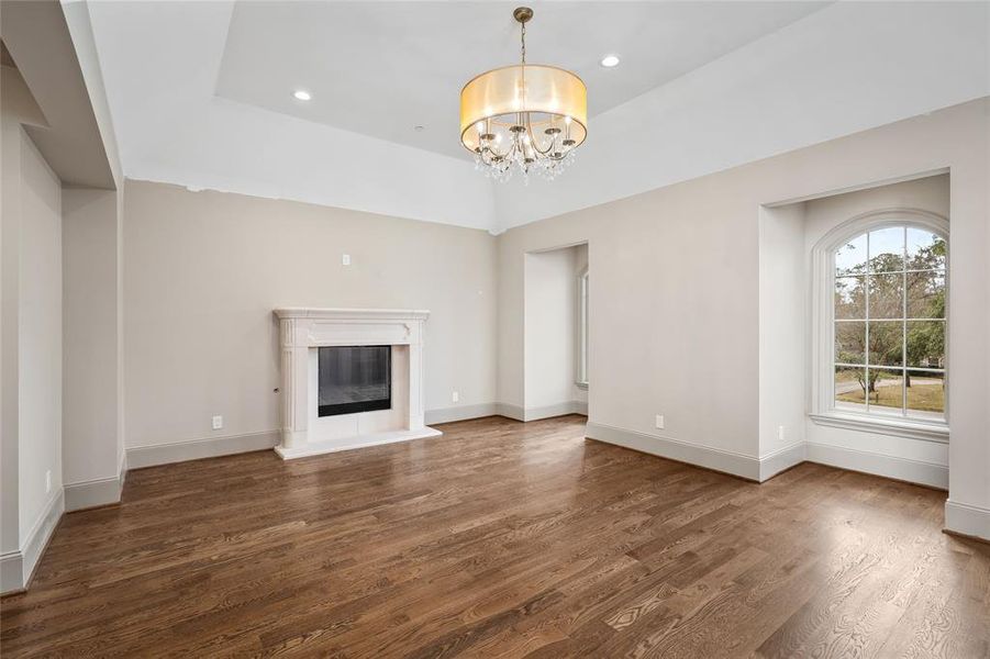 A second study on the second floor features a fireplace, handsome lighting and arched windows.