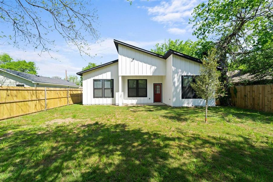 Back of house featuring a lawn