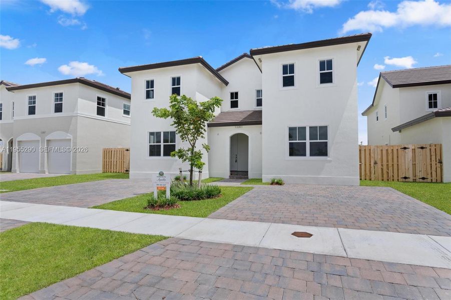 Front exterior of a new home in , Homestead, FL, highlighting curb appeal (Image 2). Front exterior of a new home in , Homestead, FL, highlighting curb appeal (Image 2).