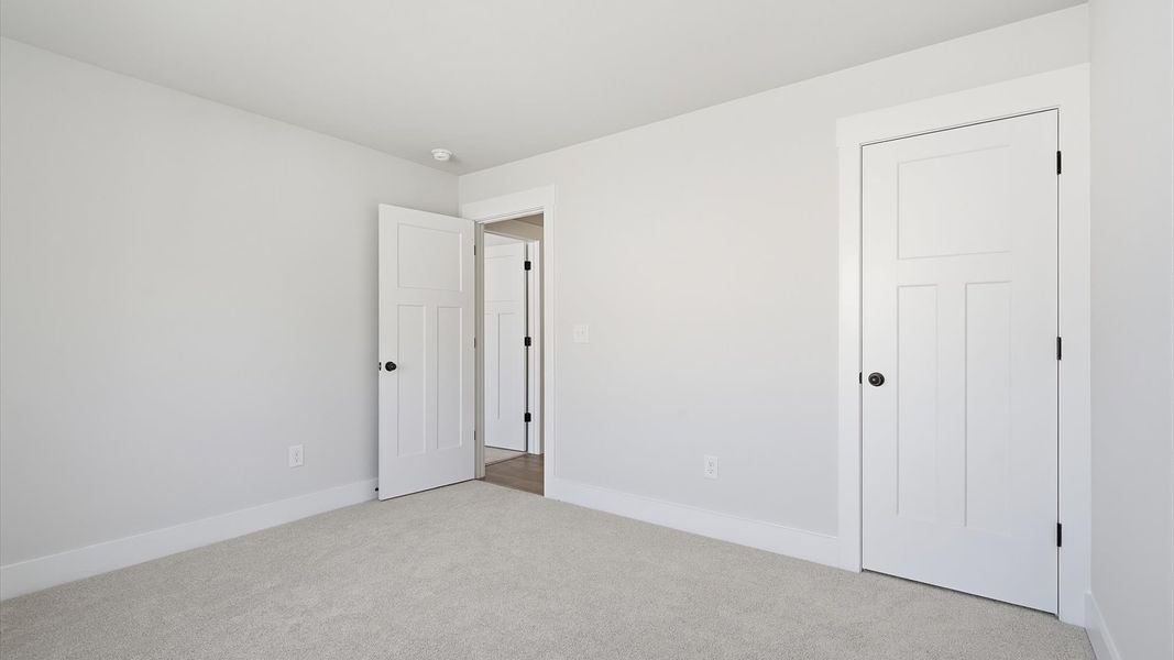 Vibrant and restful bedroom with oversized windows, refined detail, and a warm, welcoming atmosphere