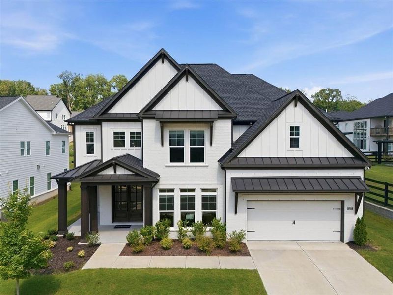 Front exterior of a new home in , Woodstock, GA, highlighting curb appeal (Image 1). Front exterior of a new home in , Woodstock, GA, highlighting curb appeal (Image 1).