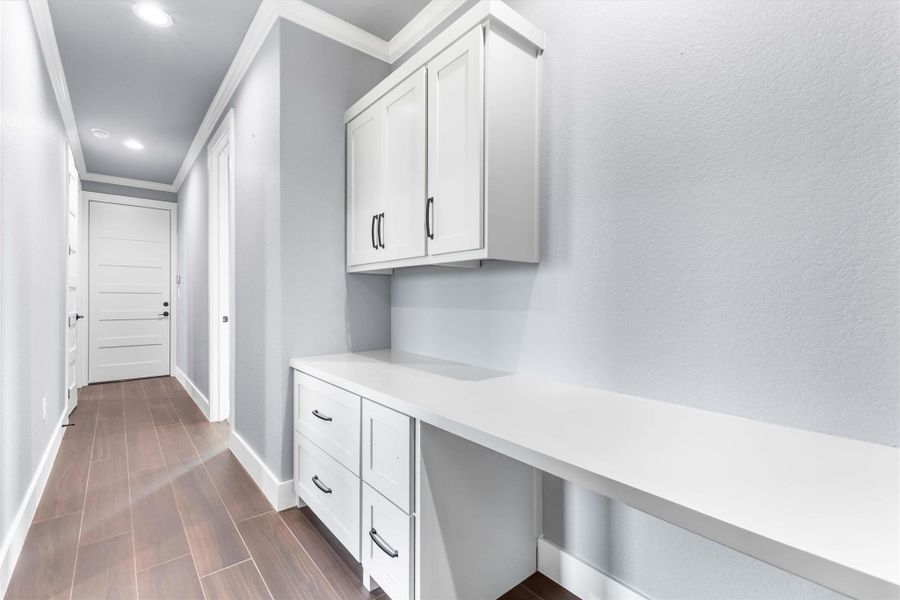 Mudroom featuring ornamental molding, baseboards, recessed lighting, and dark wood finished floors Mudroom featuring ornamental molding, baseboards, recessed lighting, and dark wood finished floors