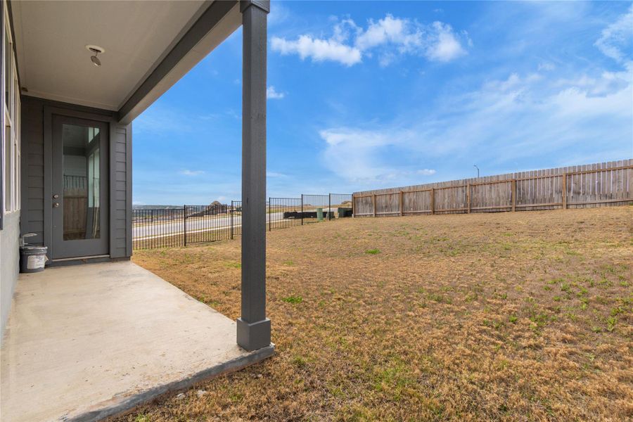A spacious backyard with privacy fencing, perfect for outdoor activities or future landscaping projects.