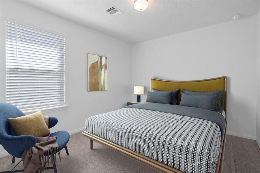 Secondary bedroom features plush carpet, neutral paint, lighting, large window with privacy blinds and ample sized closet space.