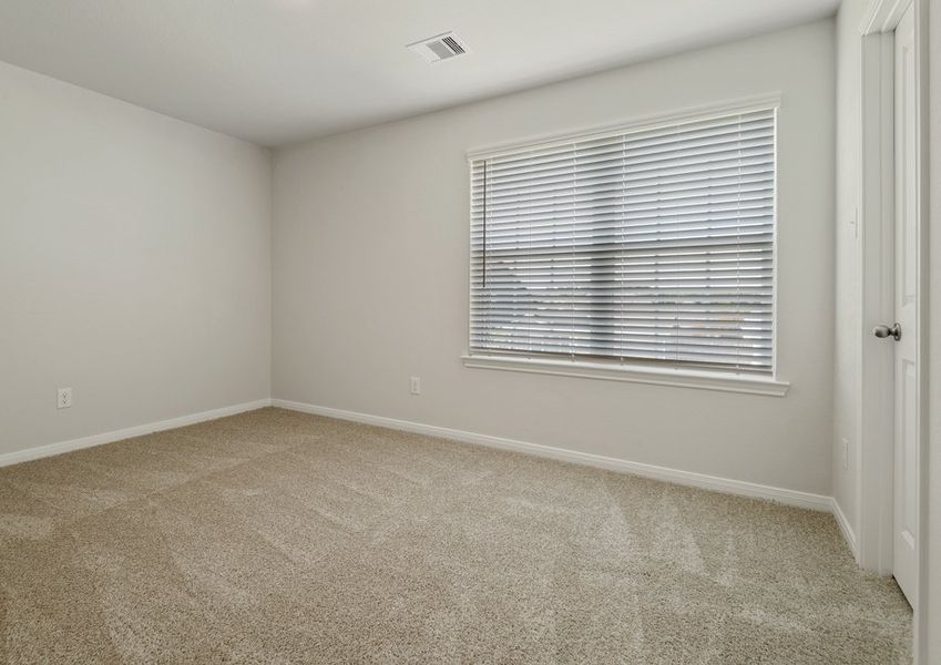 Secondary bedroom with lush carpet flooring