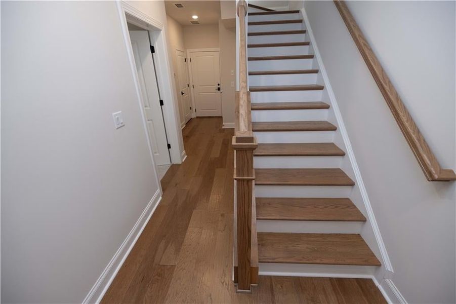 Stairs featuring hardwood / wood-style floors