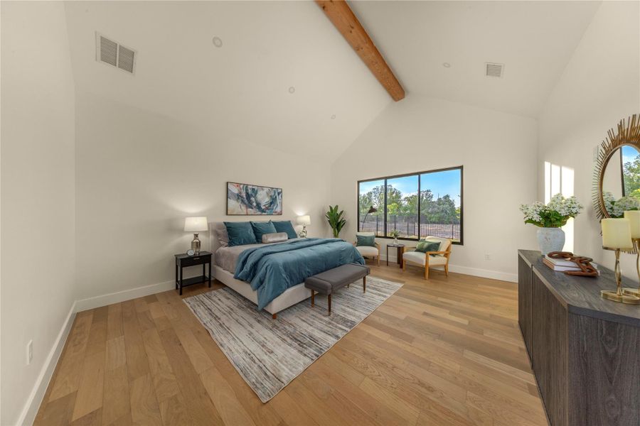 Bedroom with light wood-style flooring and vaulted ceiling