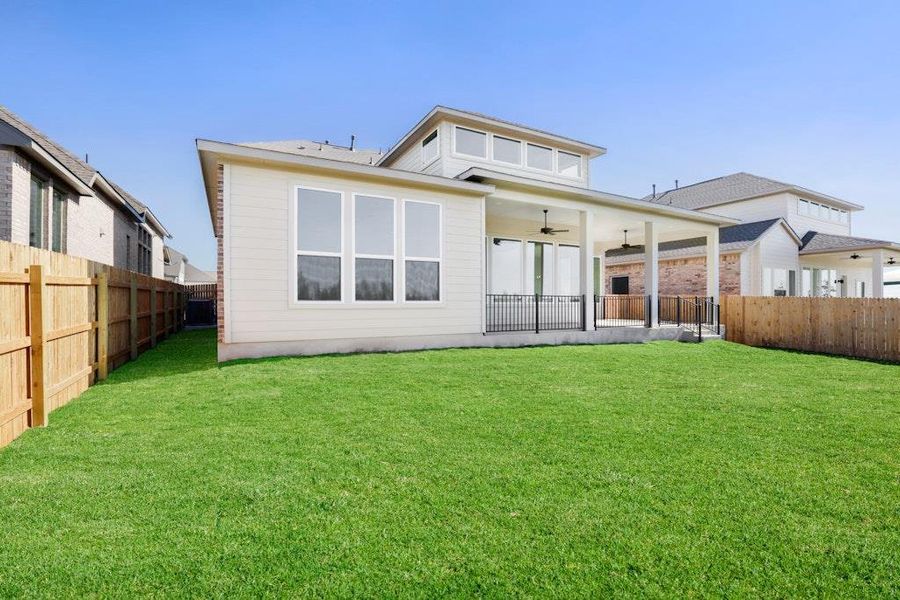 Back of house with ceiling fan, a patio, and a fenced backyard Back of house with ceiling fan, a patio, and a fenced backyard