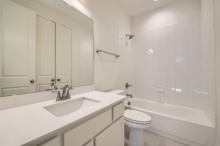 Bathroom with toilet, vanity, and shower / tub combination