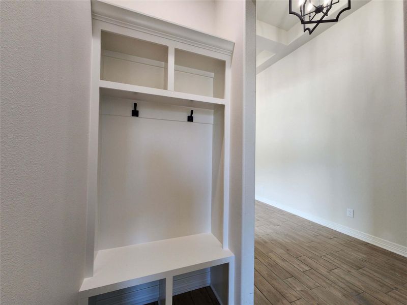 Mudroom featuring wood finished floors and baseboards