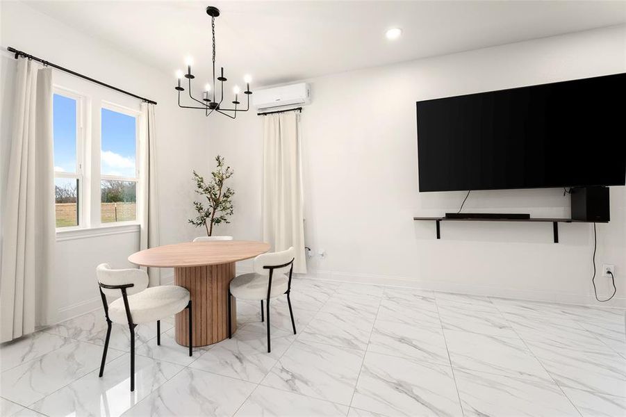 Spacious room featuring large windows, a sleek wall-mounted media shelf, and white marble-finish flooring Spacious room featuring large windows, a sleek wall-mounted media shelf, and white marble-finish flooring