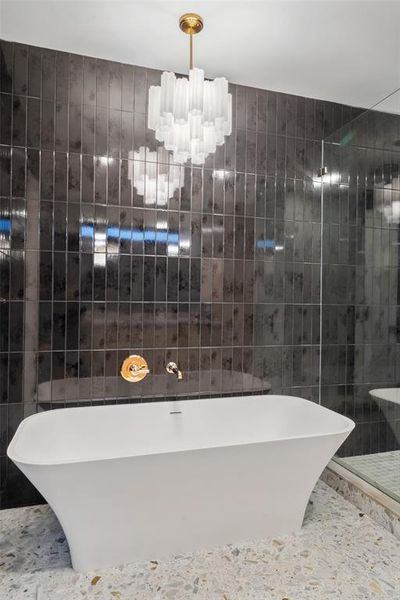 Tub in Primary Bath is accentuated by a Tronchi glass chandelier