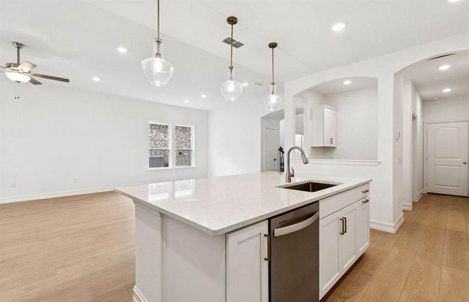 Large island overlooking gathering room and dining areas