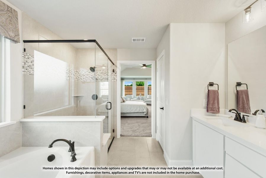 Master bathroom with glass shower, soaking tub, white vanity, and view into the bedroom