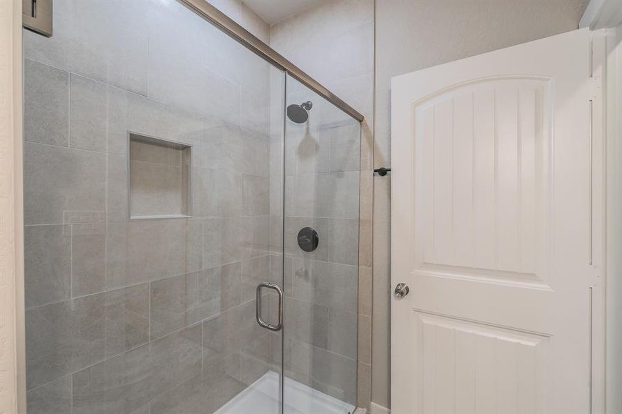 Bathroom featuring a shower with shower door