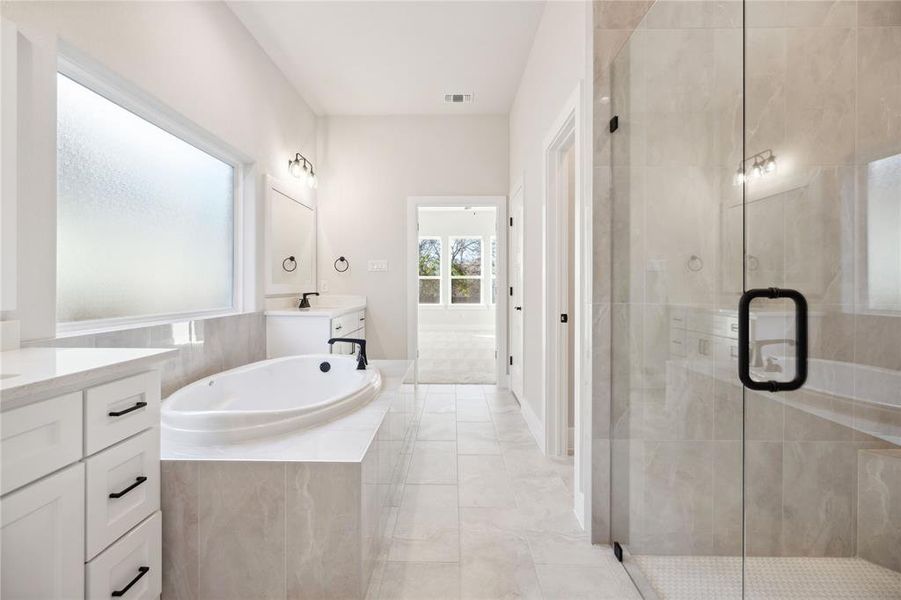 Bathroom with vanity and independent shower and bath